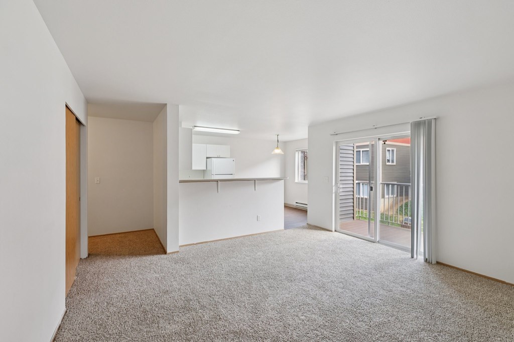 A large, empty room with a carpeted floor and white walls.at The Timbers by Vintage, Washington 98223