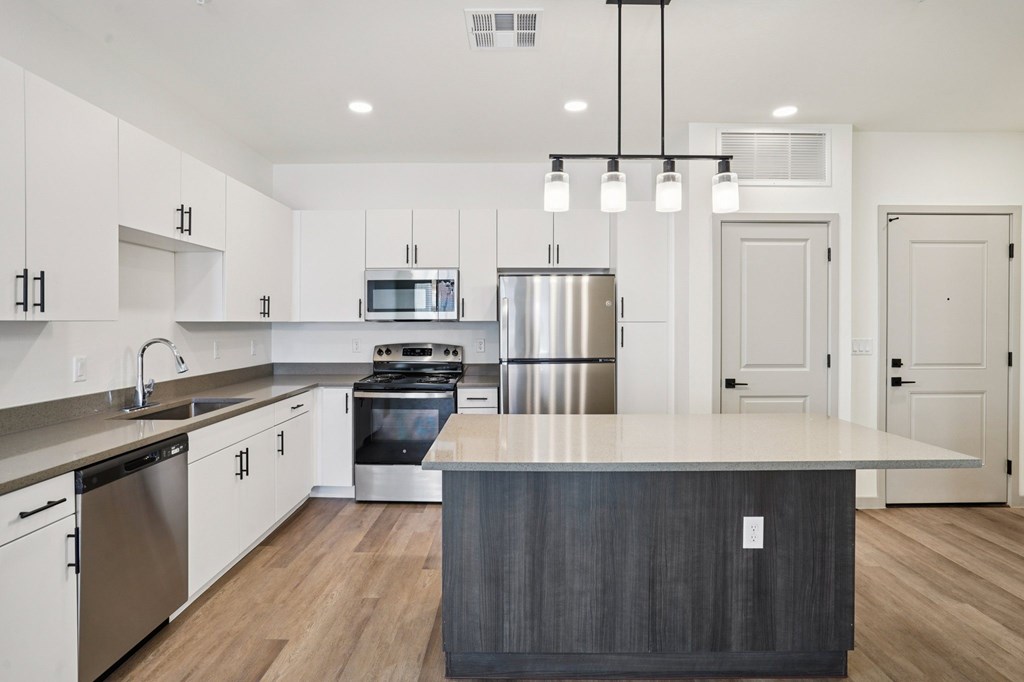 A modern kitchen with a large island in the center.at Cottonwood Ranch, Casa Grande Arizona