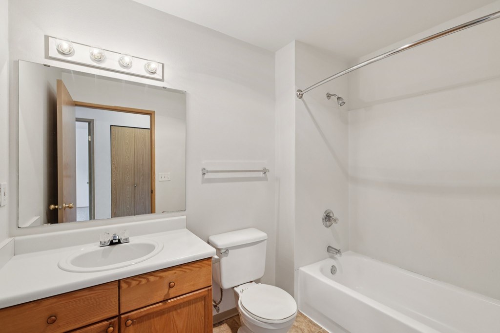 A white bathroom with a sink, toilet, and bathtub.at The Timbers by Vintage, Arlington, WA 98223