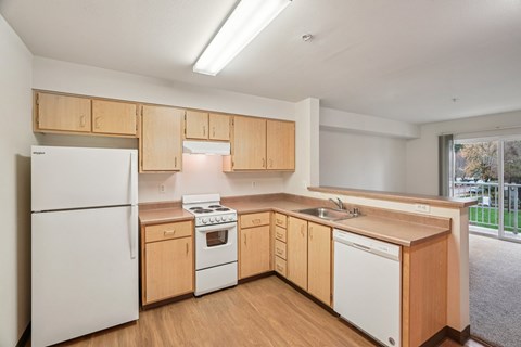 A kitchen with wooden cabinets and white appliances.