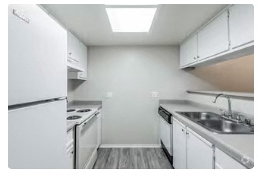 a kitchen with a stove a sink and a refrigerator