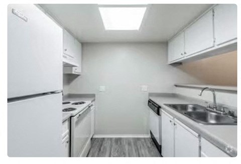 a kitchen with a stove a sink and a refrigerator