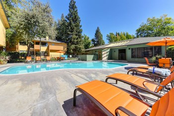 Apartments Antelope - Azure - Pool with Orange Lounge Chairs and Clubhouse - Photo Gallery 2