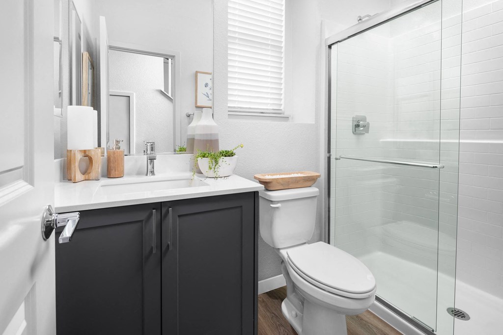 a bathroom with a toilet sink and shower