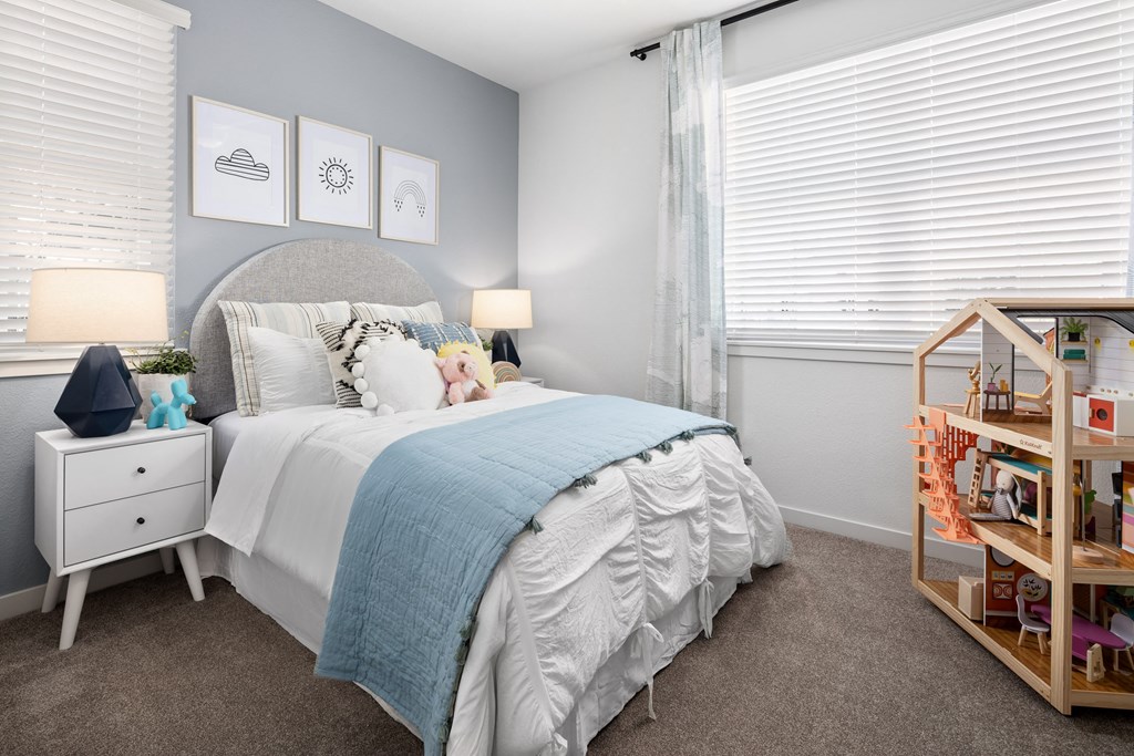 Townhouses for Rent in Roseville, CA - Solstice at Fiddyment Ranch - Bedroom with Plush Carpet Flooring, Bed, Nightstands with Lamps, Wall Decor, Accent Wall, and Two Windows with Blinds