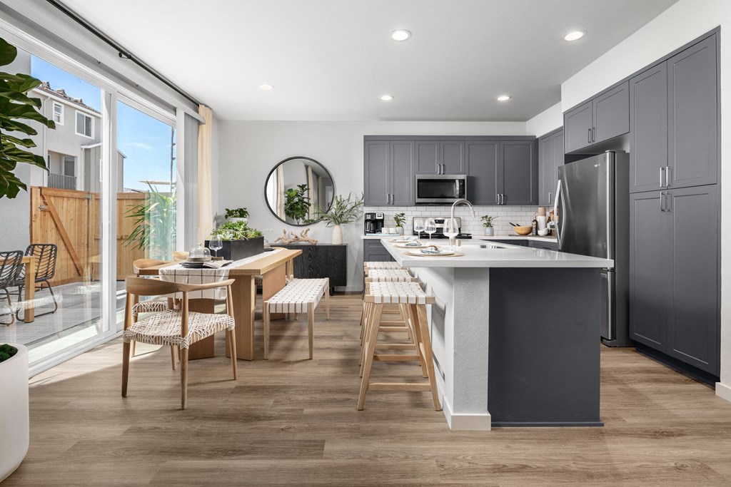 Apartments for Rent in Roseville, CA - Solstice at Fiddyment - Kitchen with Spacious Kitchen Island, Quartz Countertops, Grey Modern Cabinets, and Stainless-Steel Appliances