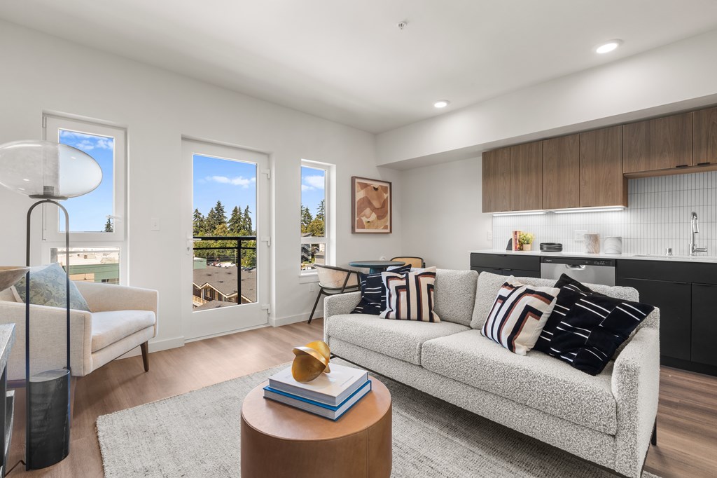 A living room with a grey couch and a wooden coffee table at Two 10 by Vintage, Shoreline, Washington