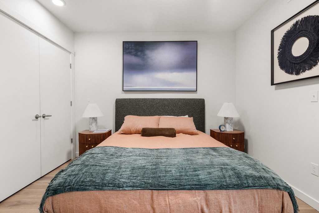 A bedroom with a bed, two lamps, and a painting on the wall at Two 10 by Vintage, Shoreline, 98133