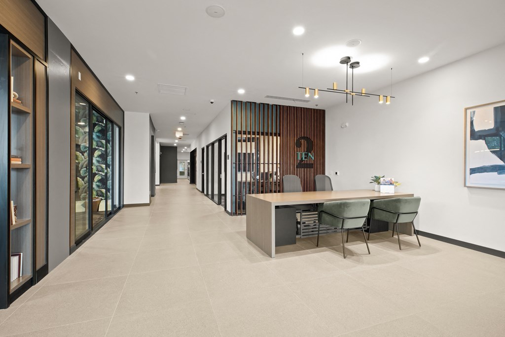 A modern office space with a long hallway, a reception desk, and a framed picture on the wall at Two 10 by Vintage, Shoreline