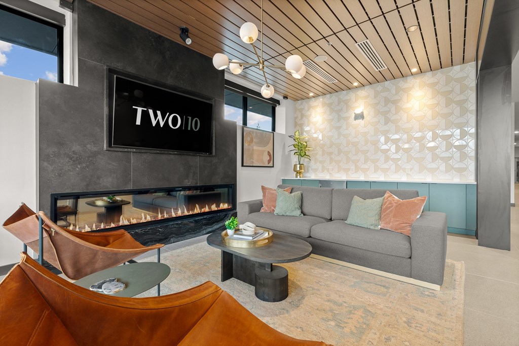 A living room with a fireplace and a grey couch at Two 10 by Vintage, Shoreline, 98133