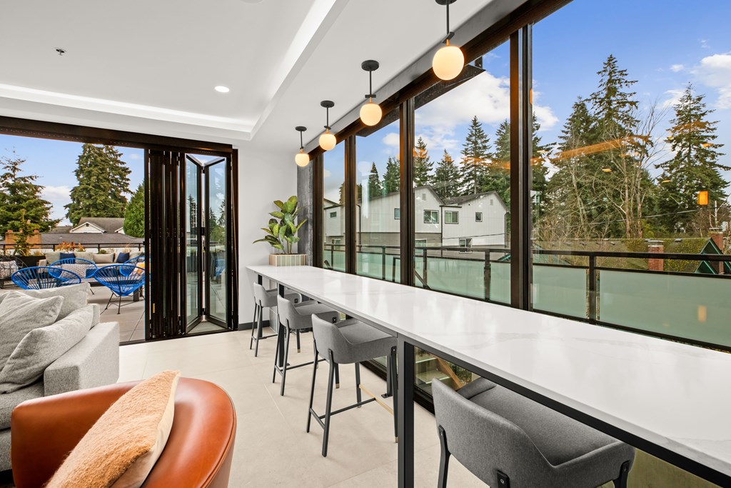 A modern living room with a long white table and chairs at Two 10 by Vintage, Shoreline, 98133
