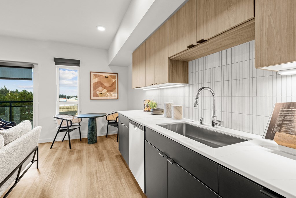 A modern kitchen with a dining table and chairs at Two 10 by Vintage, Shoreline, 98133