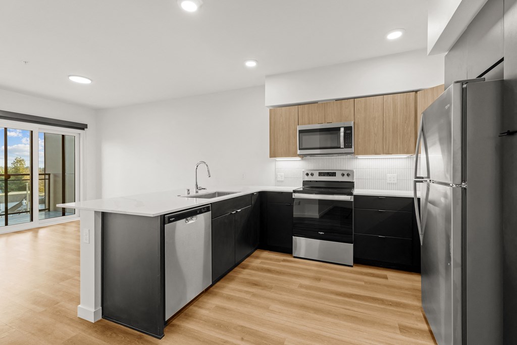 A modern kitchen with a refrigerator, sink, and oven at Two 10 by Vintage, Washington