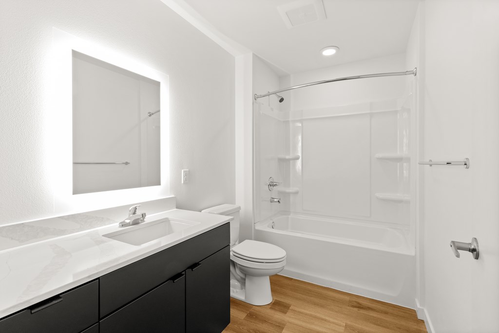 A white bathroom with a sink, toilet, and bathtub at Two 10 by Vintage, Shoreline, WA
