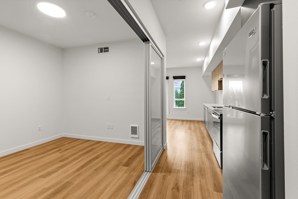 A kitchen with a refrigerator on the right side at Two 10 by Vintage, Shoreline