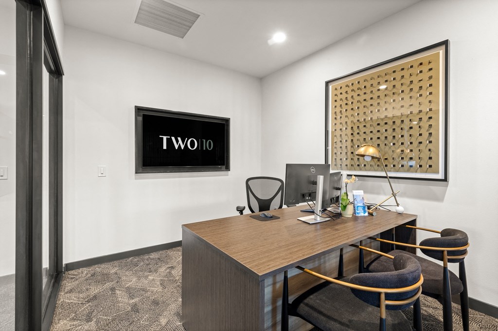 A room with a desk, chair, and a picture on the wall at Two 10 by Vintage, Washington