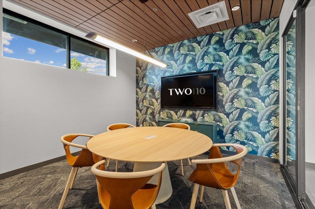 A conference room with a round table and chairs  at Two 10 by Vintage, Shoreline, WA 98133
