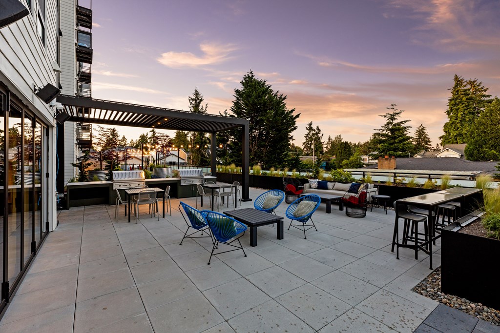 A patio with a table and chairs is set up outside  at Two 10 by Vintage, Shoreline, WA