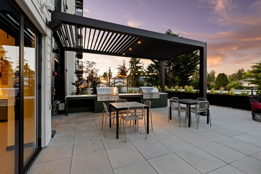 A patio with a table and chairs under a roof at Two 10 by Vintage, Shoreline, 98133