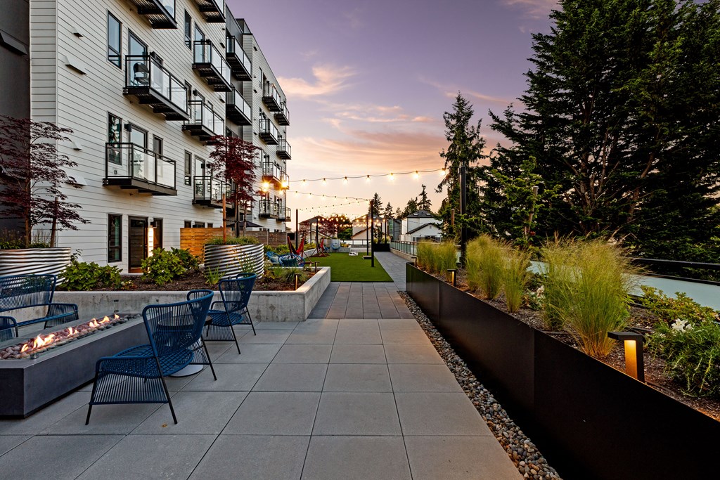 A patio with chairs and a fire pit in front of a building  at Two 10 by Vintage, WA, 98133