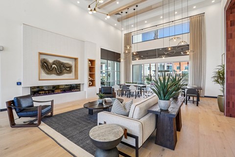 A living room with a large painting on the wall and a fireplace.