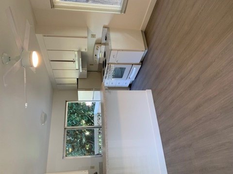 A white refrigerator is in the kitchen.