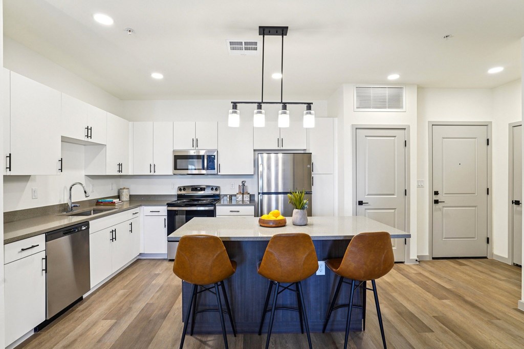 A modern kitchen with a large island and bar stools.at Cottonwood Ranch, Casa Grande