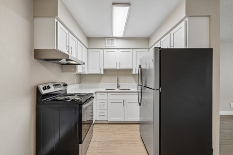 Modern kitchen with stainless steel appliances at Zoom Apartments, Las Vegas, Nevada