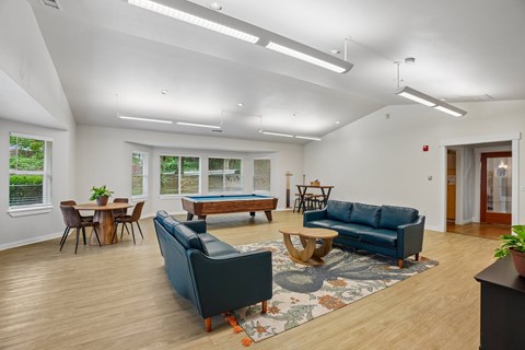 A living room with a blue couch and a wooden coffee table.