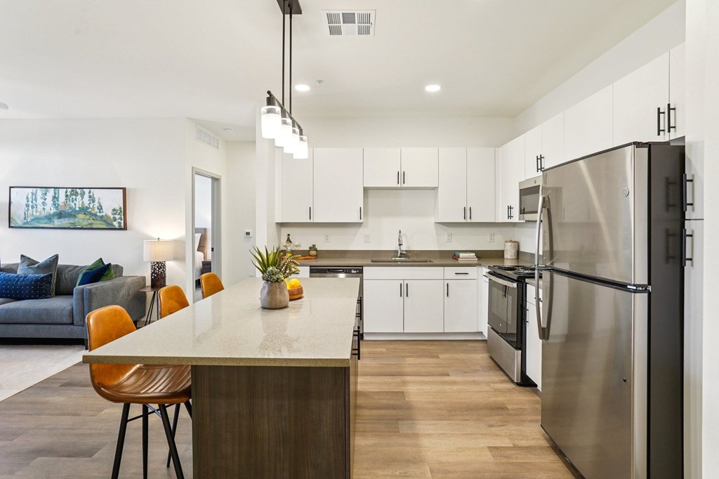 A modern kitchen with a large island and stainless steel appliances.at Cottonwood Ranch, Arizona, 85122