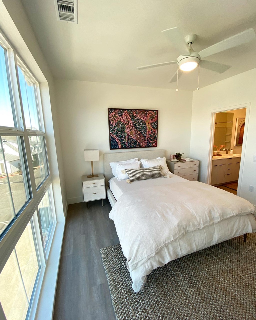a bedroom with a large bed and a ceiling fan