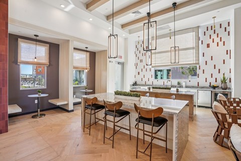 A modern kitchen with a dining table and chairs.