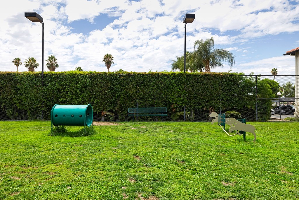 a green park with a green bench and a green hedge