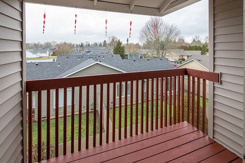 Apartments for rent in Keizer OR - The Village - FPI - Outside Private Patio with Wood Railing at THE VILLAGE Apartments, Oregon