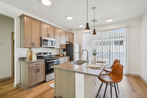 A kitchen with a table and chairs.