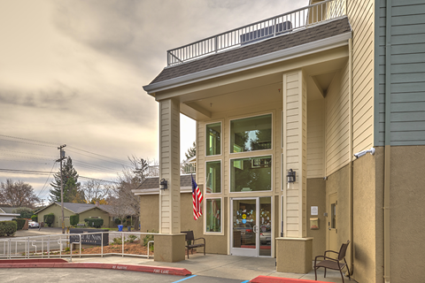 A building with a balcony and an American flag.