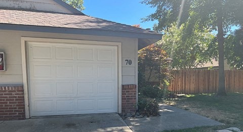a white garage door on the side of a house