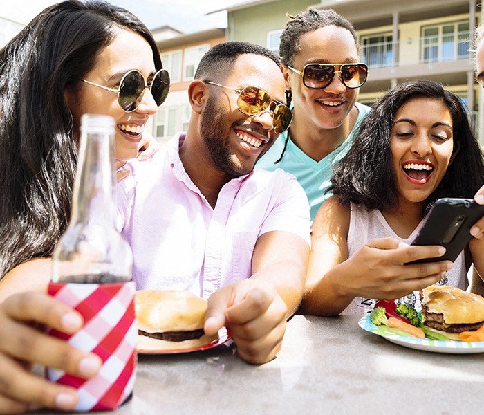 Group of friends at bbq by pool