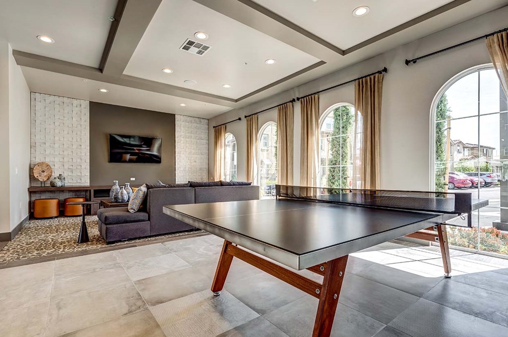 Apartments for Rent Livermore CA - Ageno - Clubhouse Game Area With a Table Tennis, Comfortable Seating, and a TV