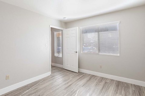 Bedroom with window and wood floors