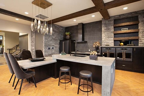 a large kitchen with an island and chairs