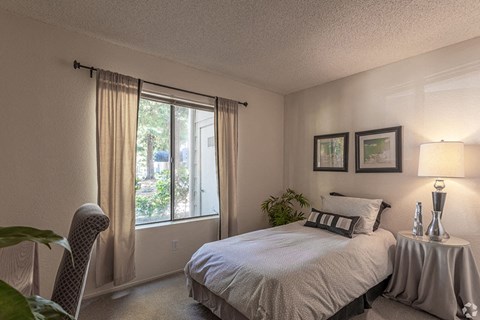 Ashford Park bedroom with large windows and carpeting