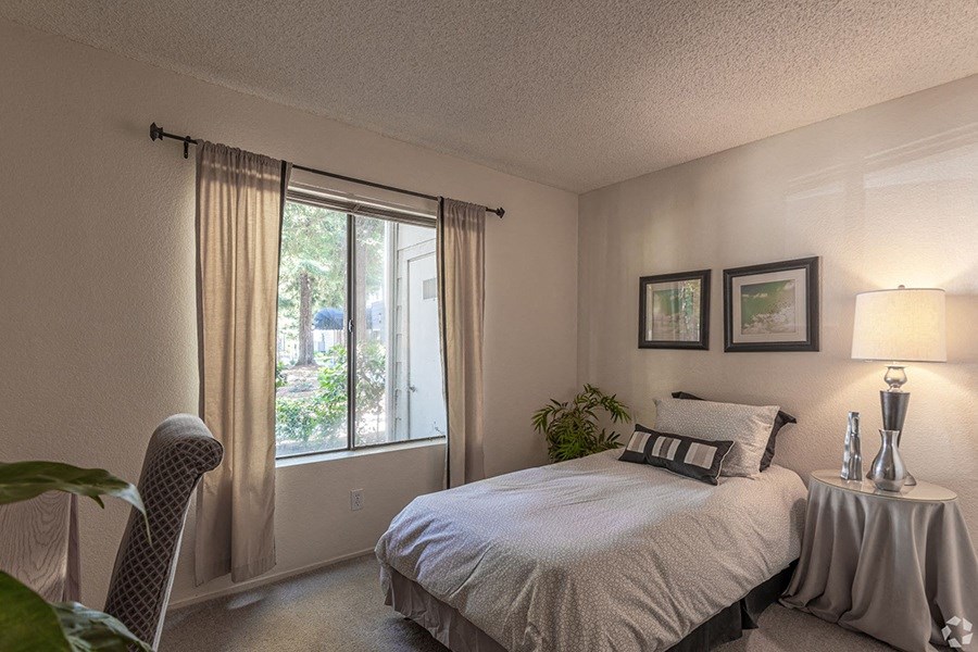 Ashford Park bedroom with large windows and carpeting