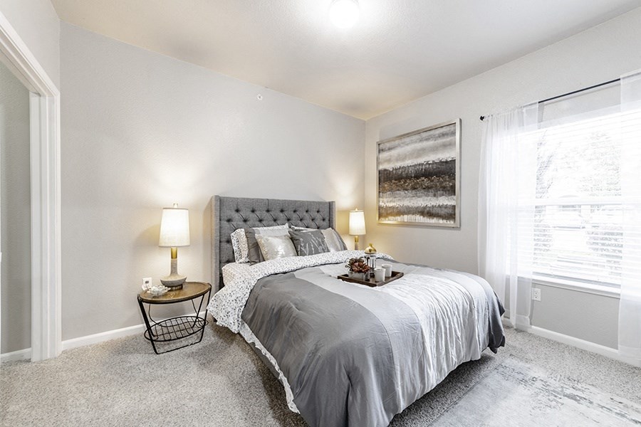 a bedroom with a bed and a window