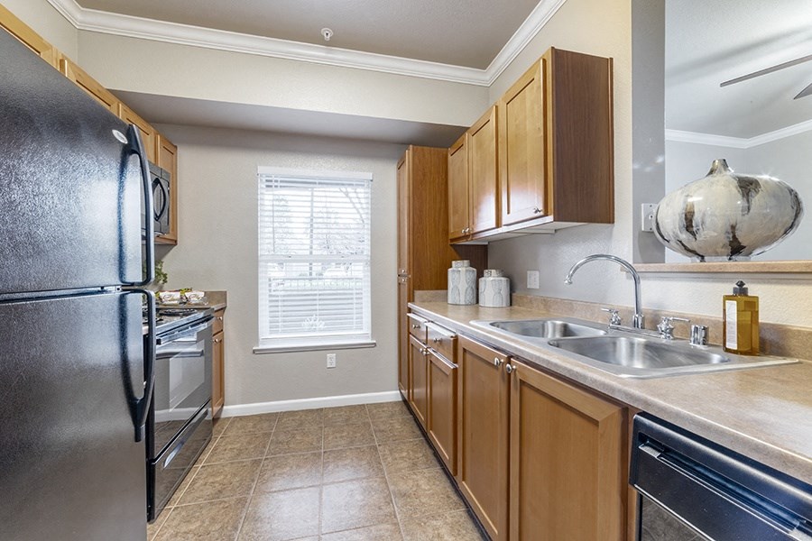 a kitchen with stainless steel appliances and wooden cabinets