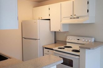 Apartments for Rent in Des Moines - Marina Club - Kitchen with White Appliances, Spacious Countertops, and White Cabinets