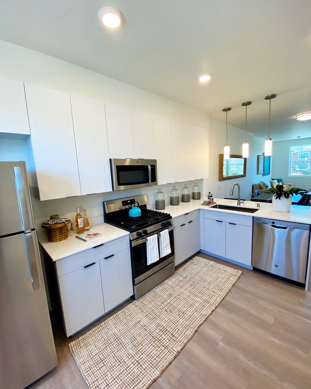 a kitchen with white cabinets and stainless steel appliances