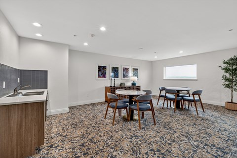 A dining room with a table set for six.