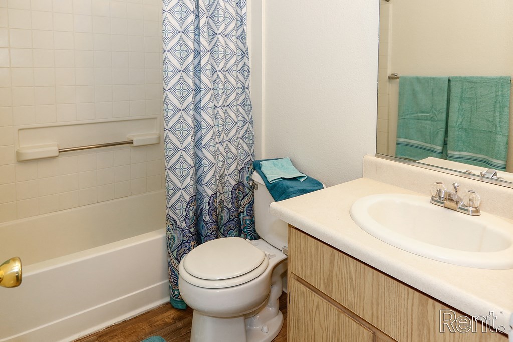 a bathroom with a toilet sink and bathtub
