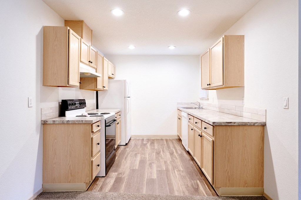 Updated kitchens with refrigerator and stove at Devonwood and First Place Apartments, Battle Ground, 98604